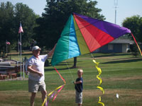 Williamson back pain free grandpa and grandson playing with a kite